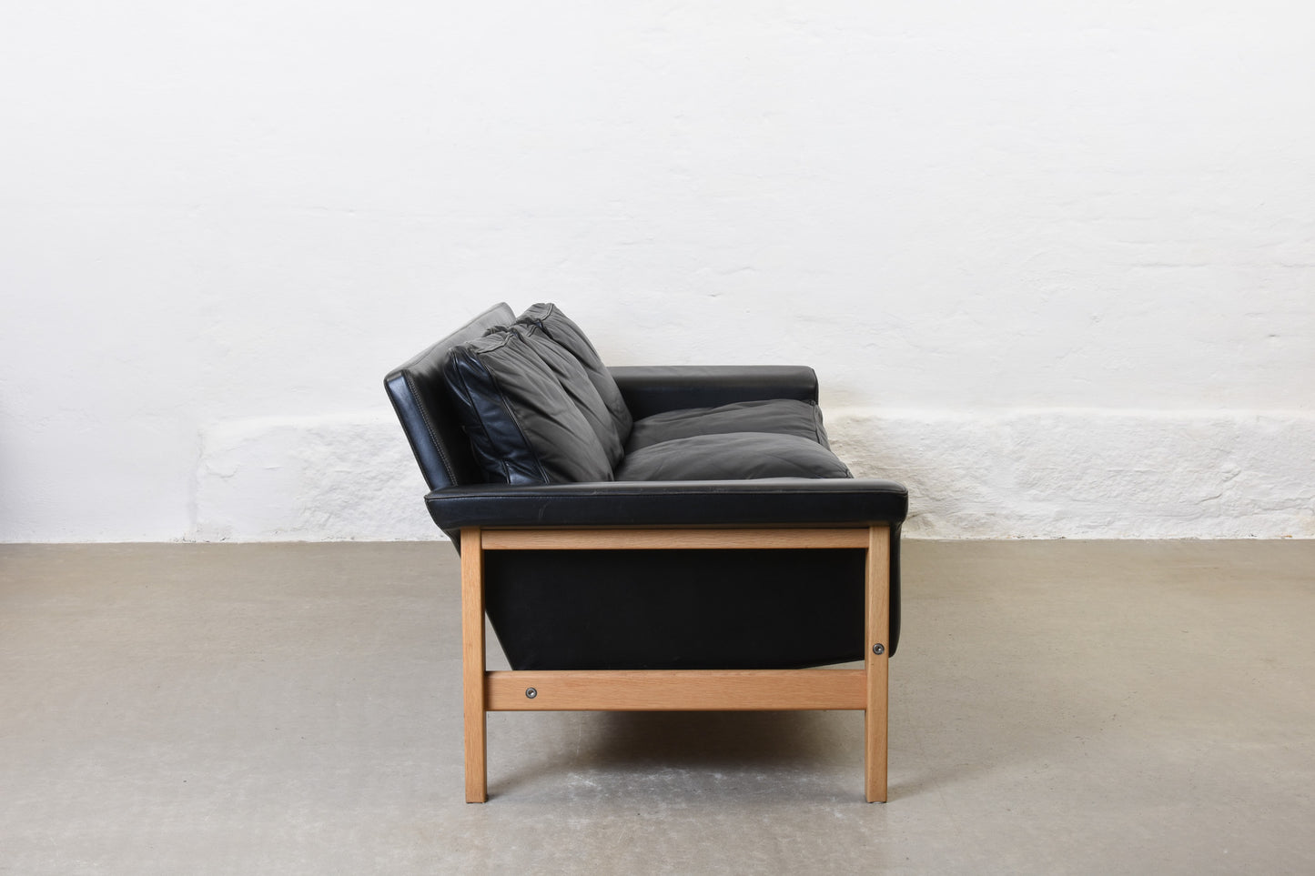 1960s leather + oak three seater by Ulferts