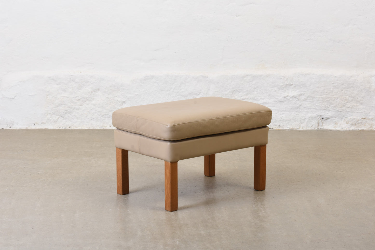 1980s leather foot stool on oak legs