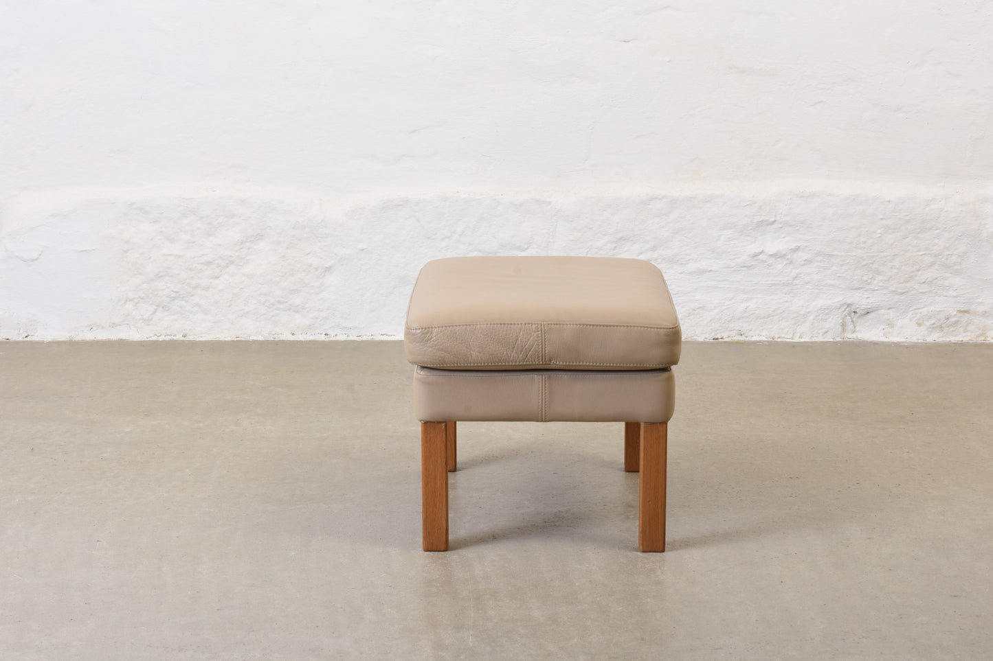1980s leather foot stool on oak legs