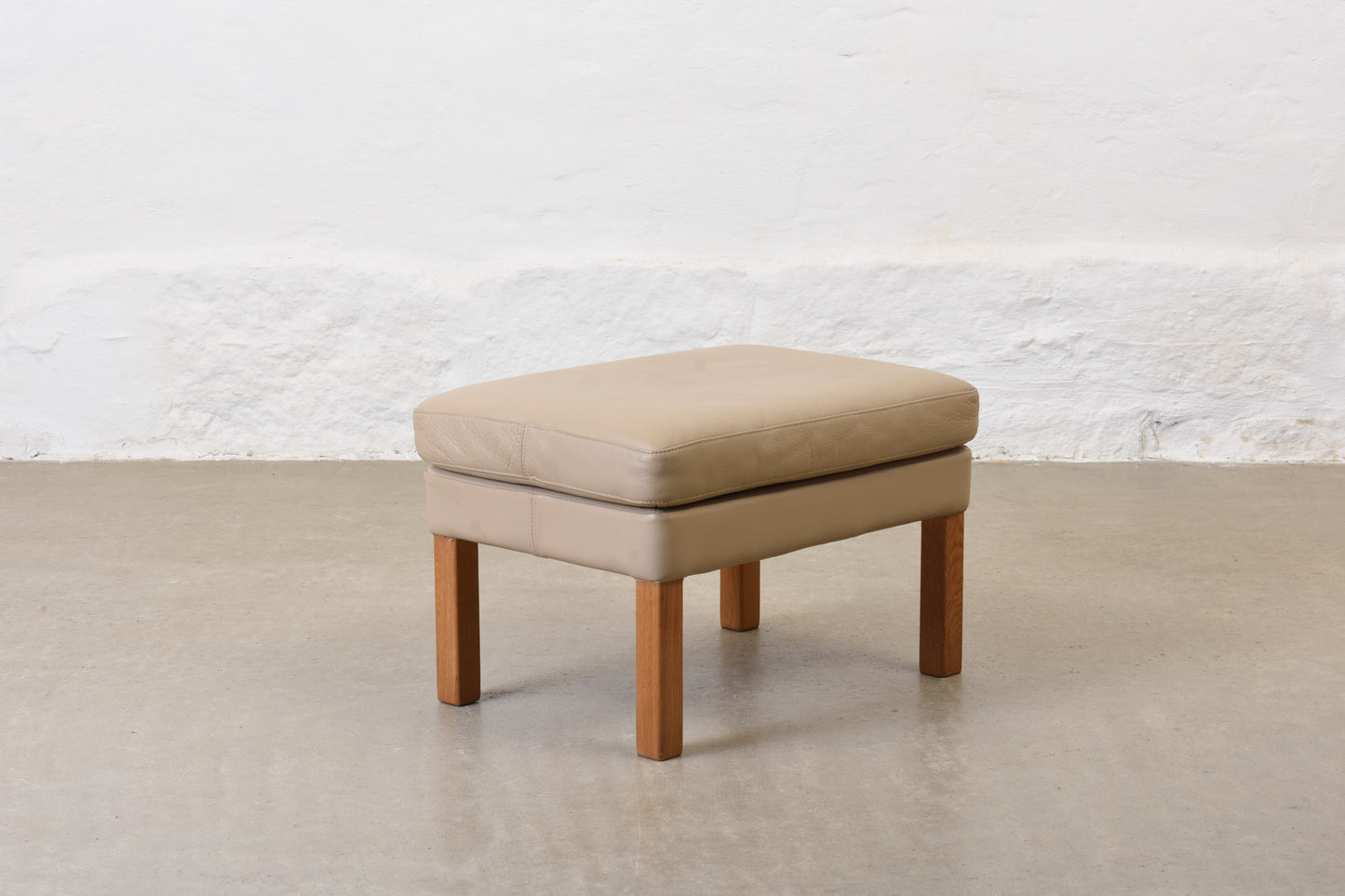 1980s leather foot stool on oak legs
