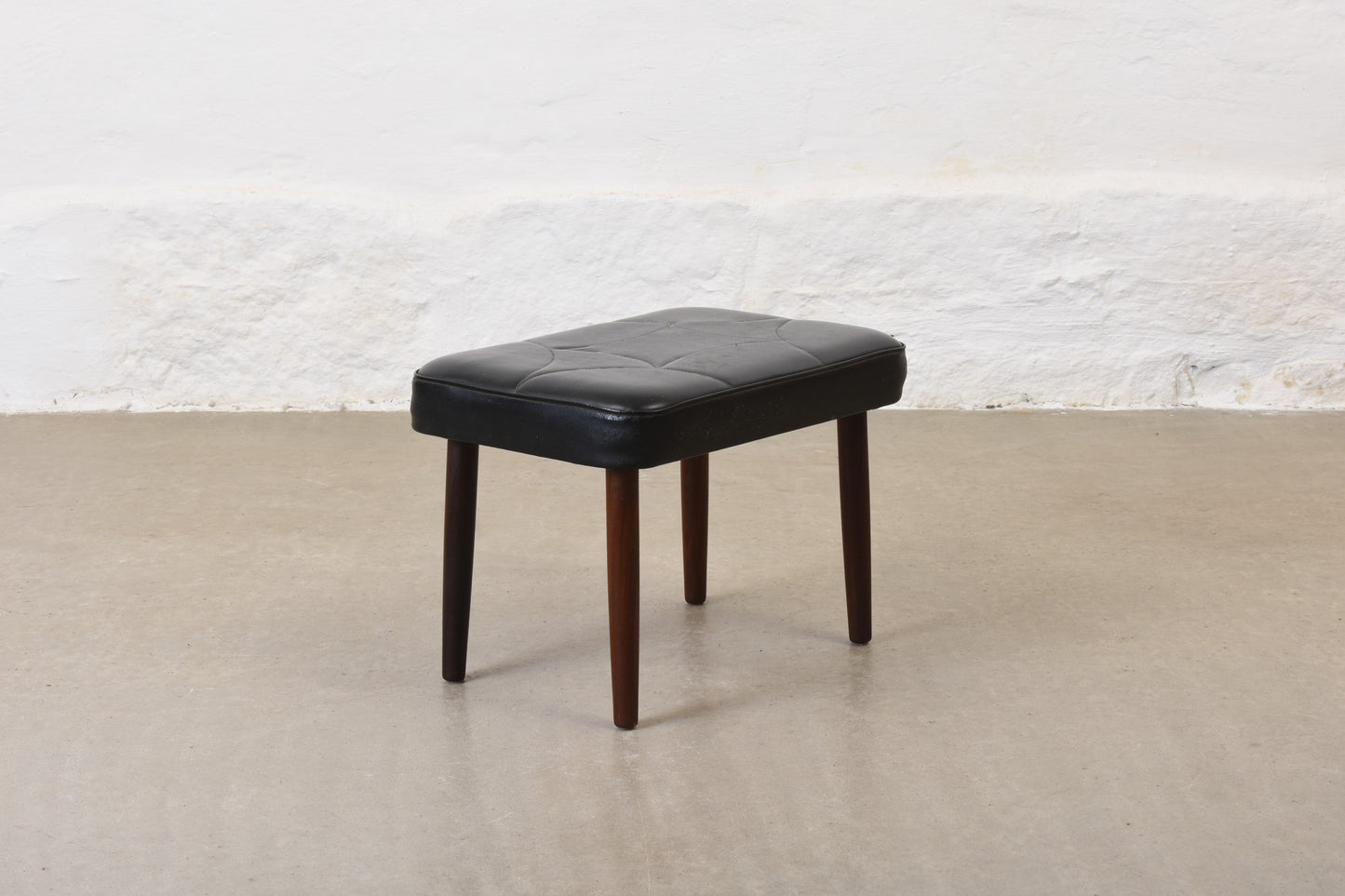 1960s vinyl footstool on teak legs