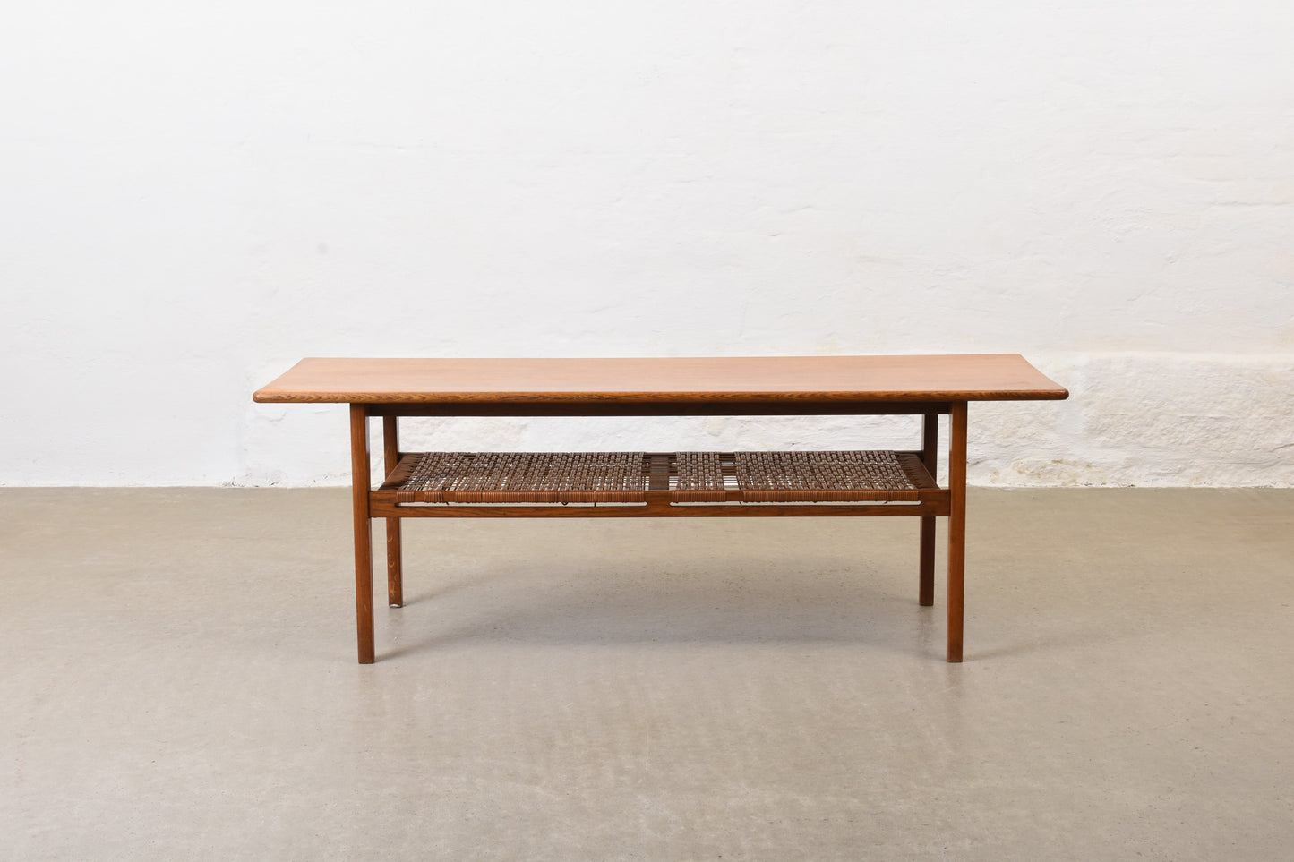 1960s oak coffee with cane magazine shelf