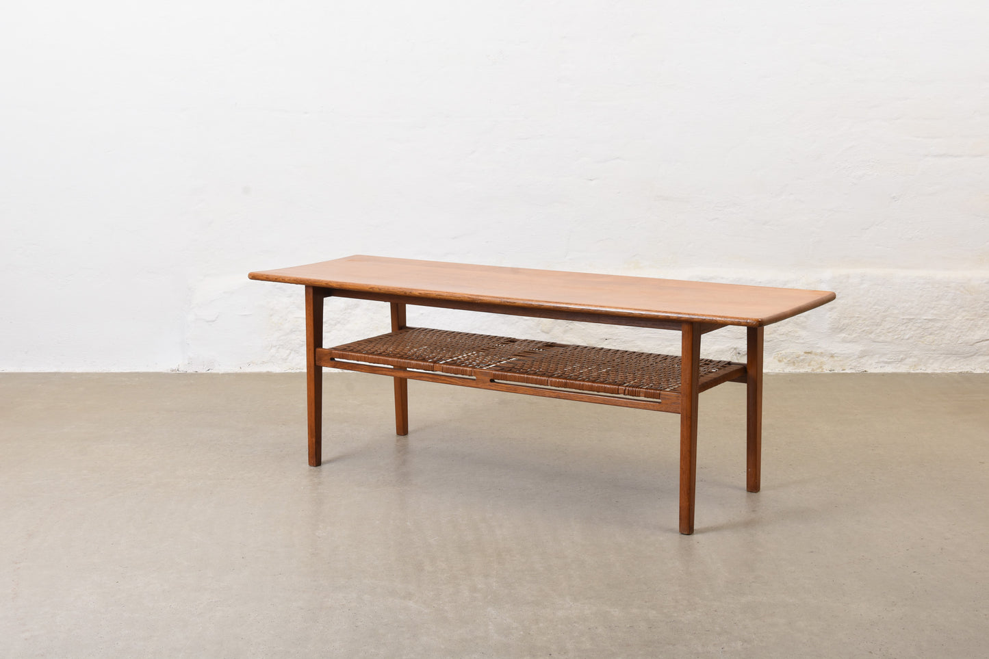 1960s oak coffee with cane magazine shelf