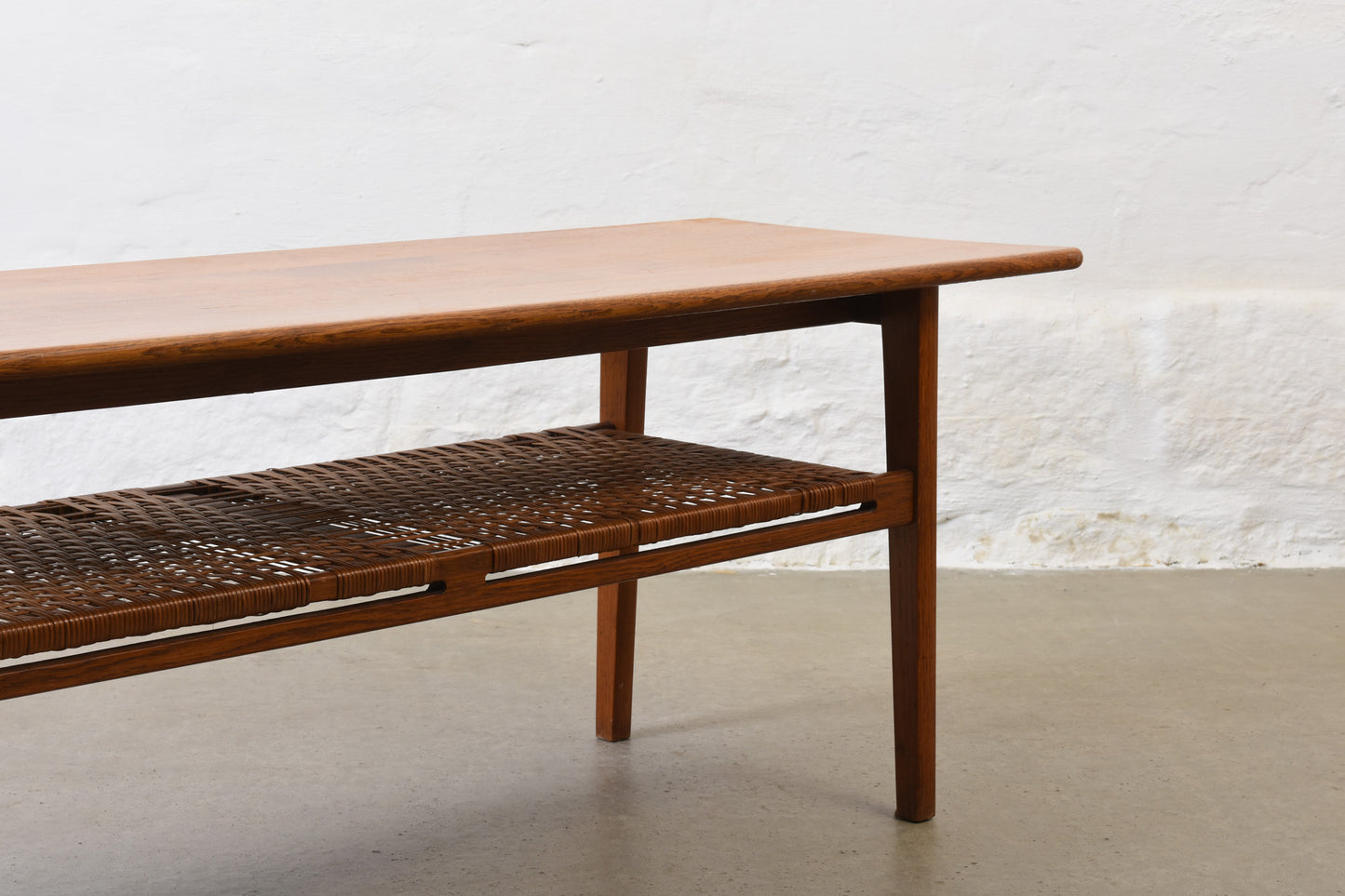 1960s oak coffee with cane magazine shelf