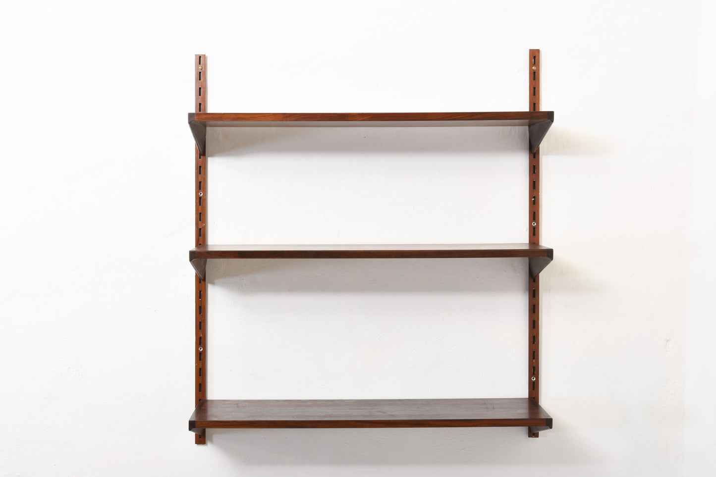 1960s bay of three rosewood shelves by Kai Kristiansen