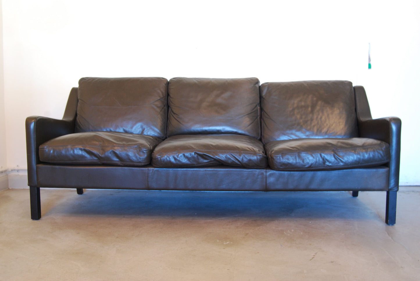 Three seat sofa in black leather