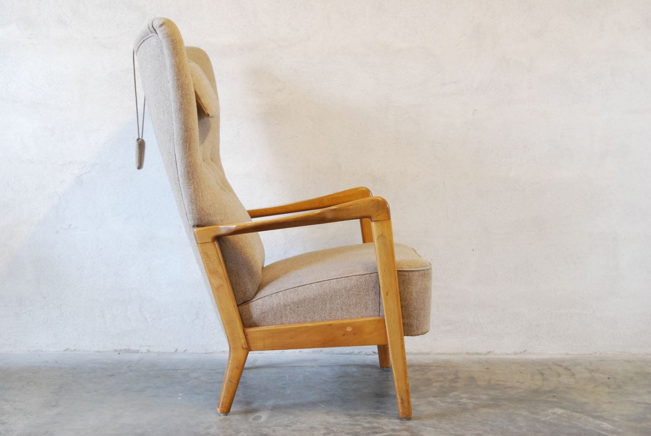 Wingback chair with grey upholstery