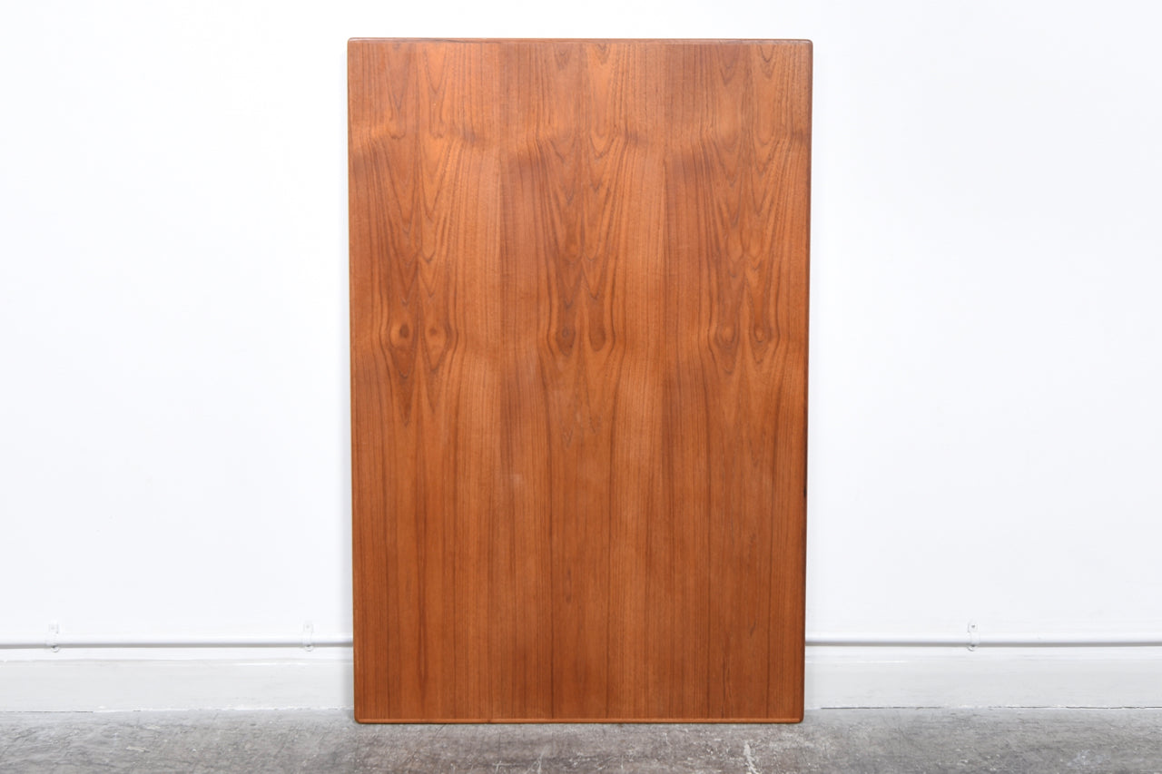 Extending rectangular dining table in teak