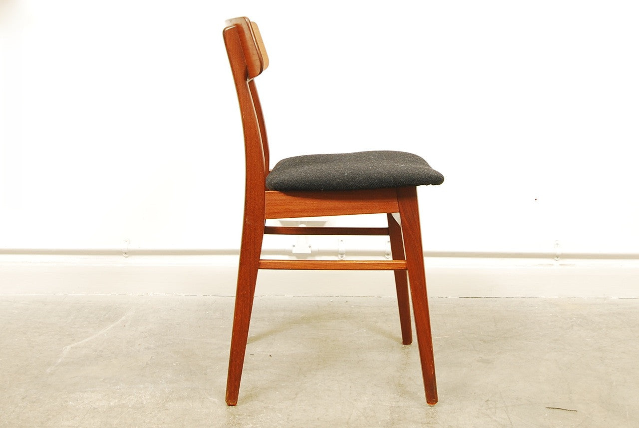 Set of four teak dining chairs with new black upholstery