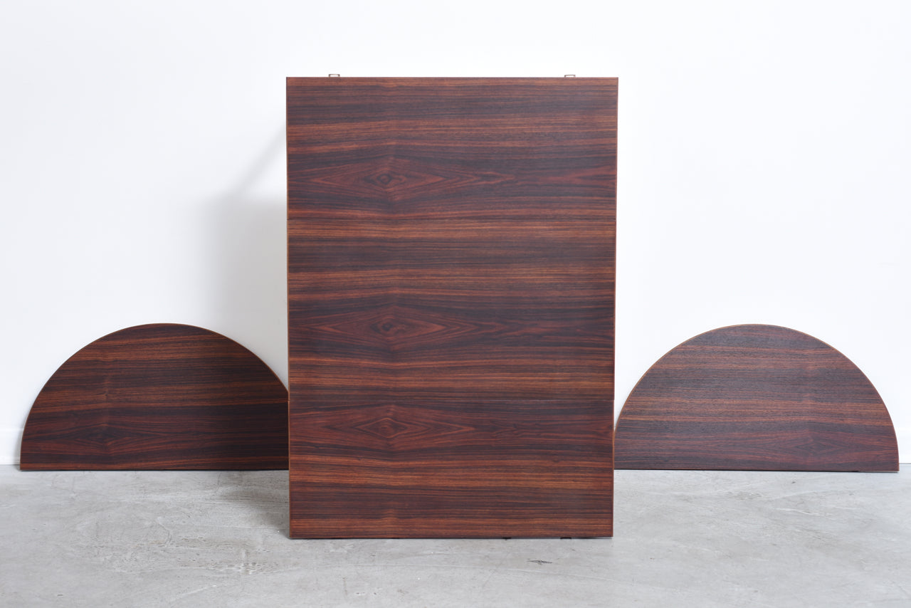 Extending dining table in rosewood