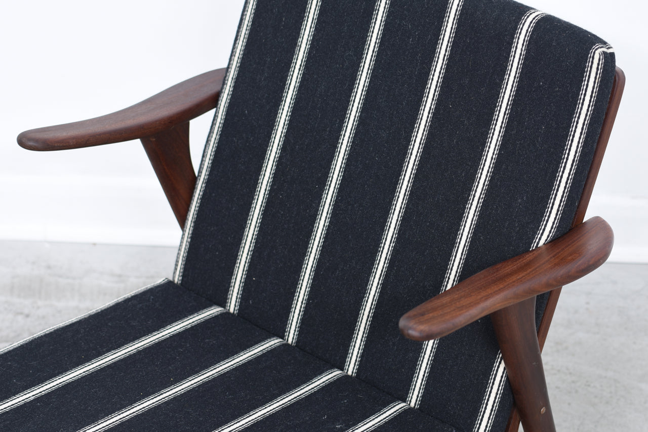 Teak lounge chair with striped cushions