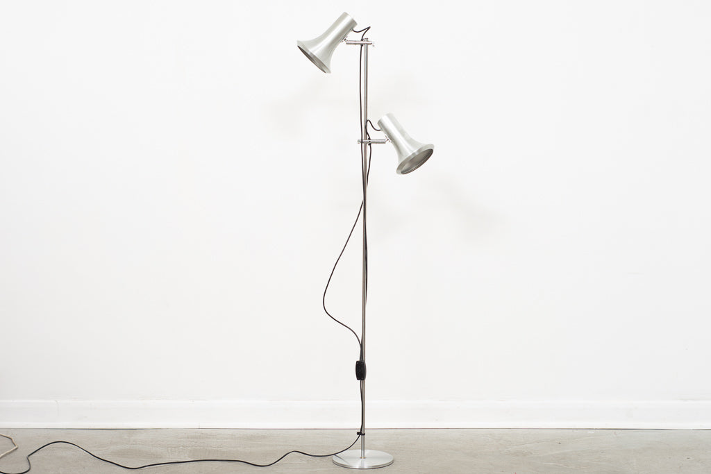 Twin-headed floor lamp with metallic finish