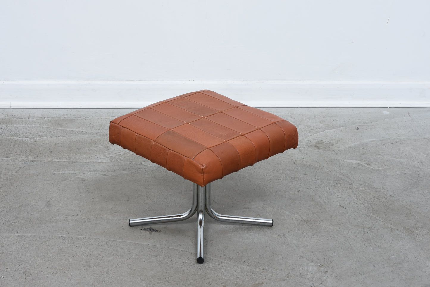 Vintage leather foot stool on metal base no. 1