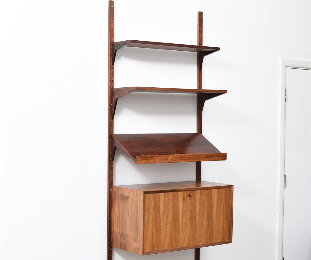 Single bay of rosewood shelving by CADO