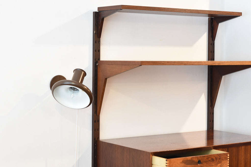 Single bay of rosewood shelving by CADO