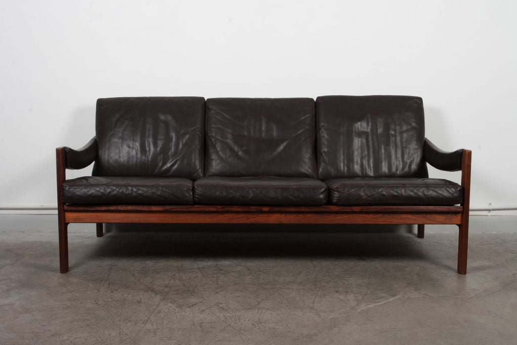 Three seat rosewood and leather sofa