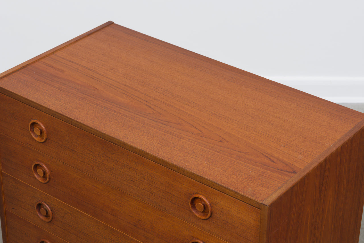 Short teak chest of five drawers