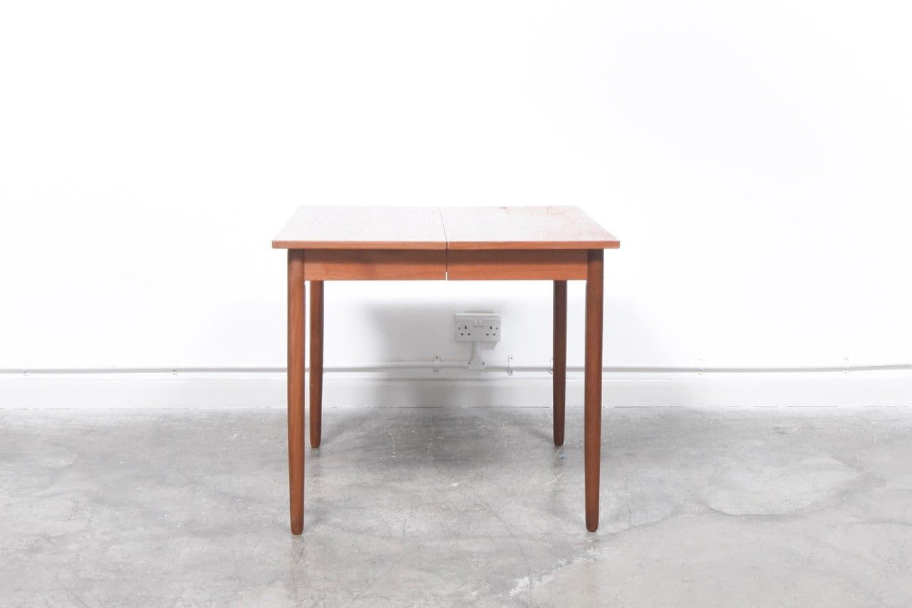 Extending teak dining table