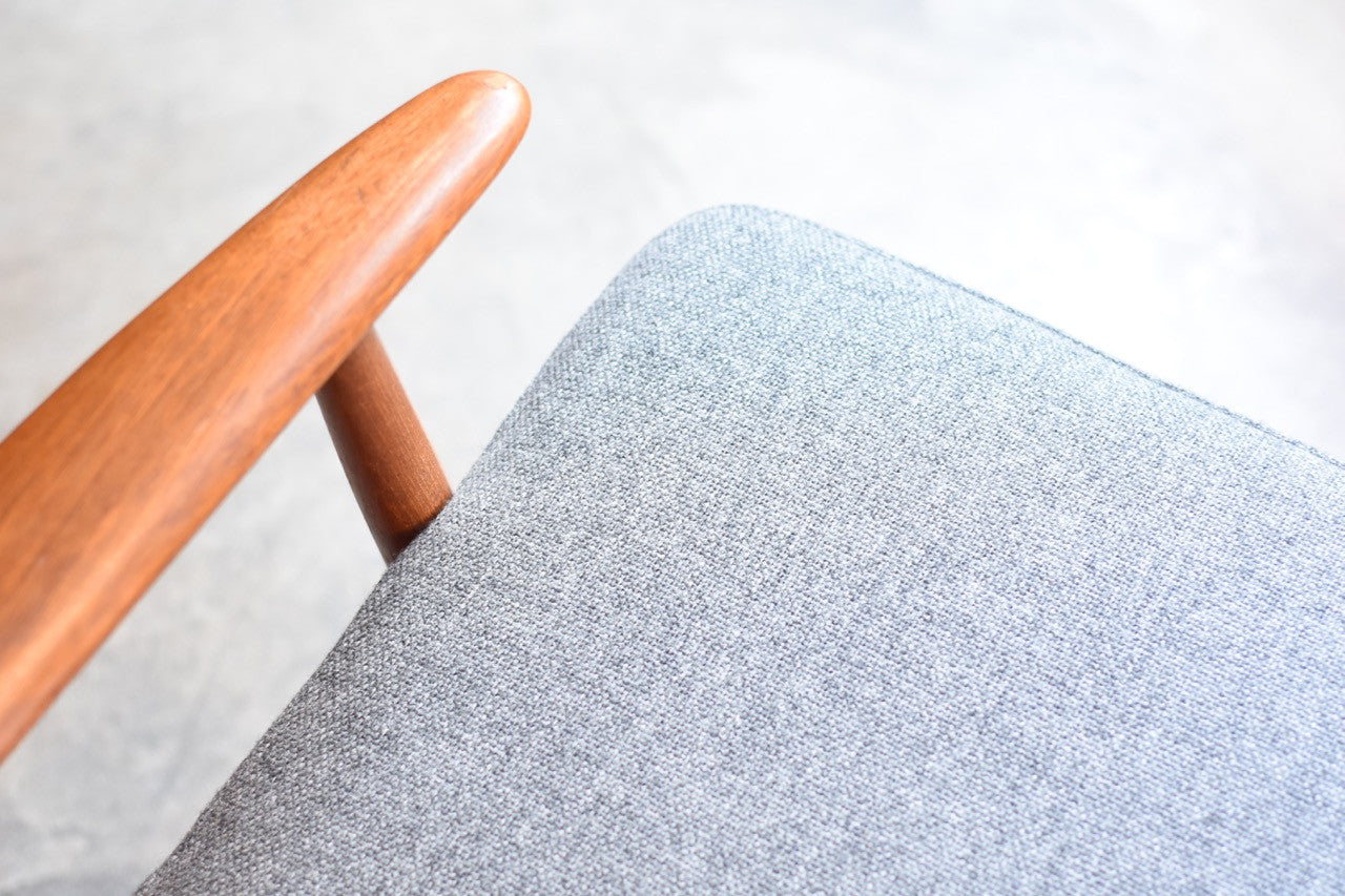 Teak lounger with grey covers