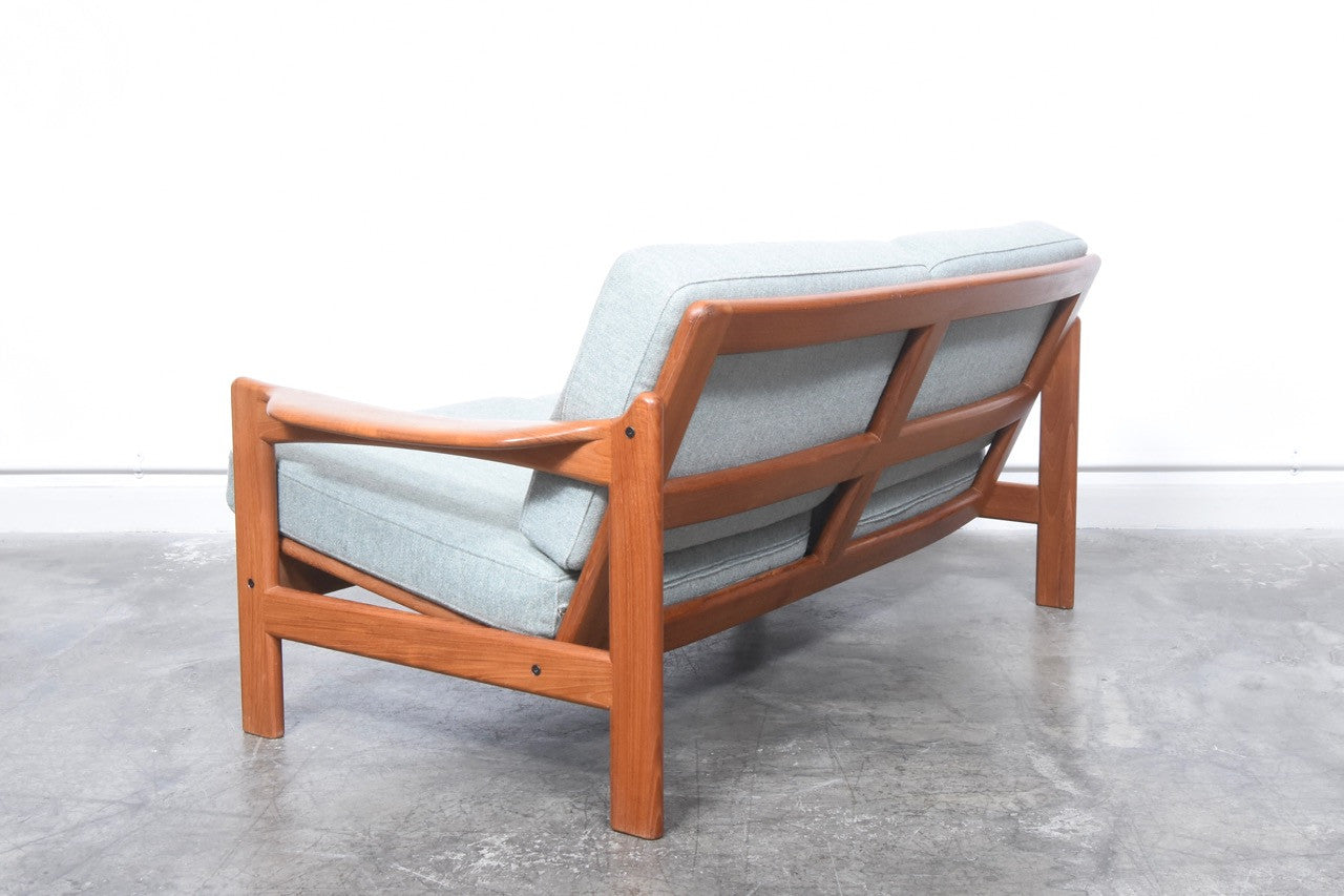 Teak-framed two seat sofa
