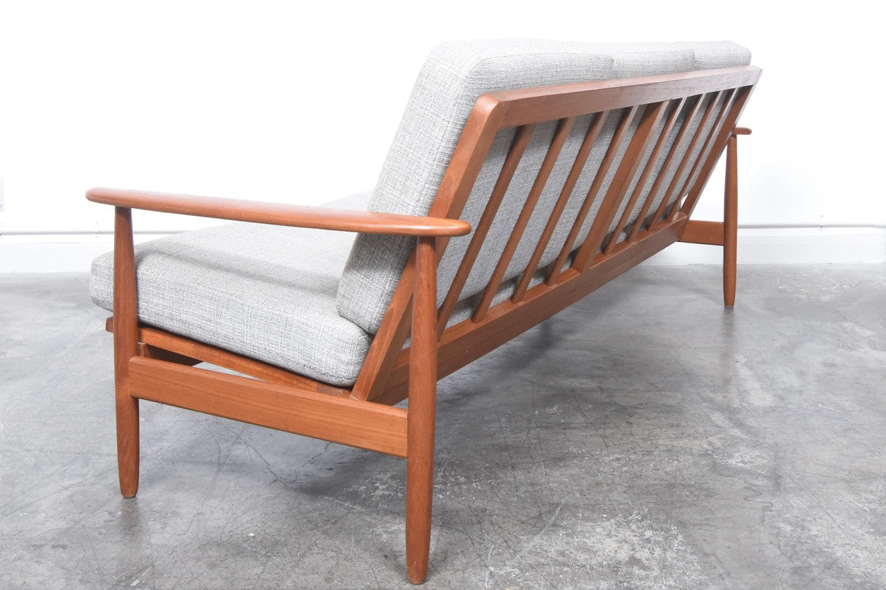 Teak-framed three seat sofa