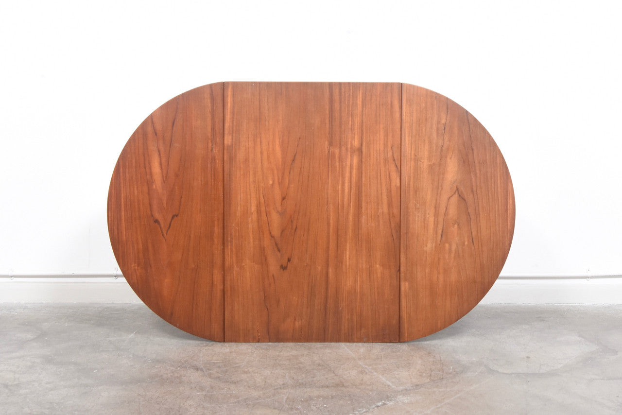 Narrow teak dining table with drop leaves