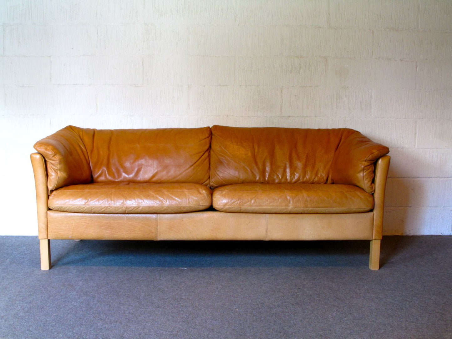 Two and a half seat leather sofa by Mogens Hansen