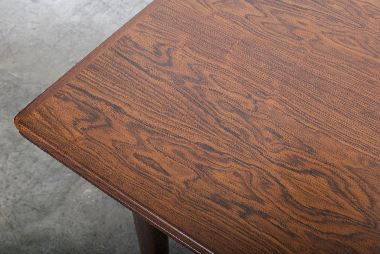 Extending rosewood dining table by Omann Junior