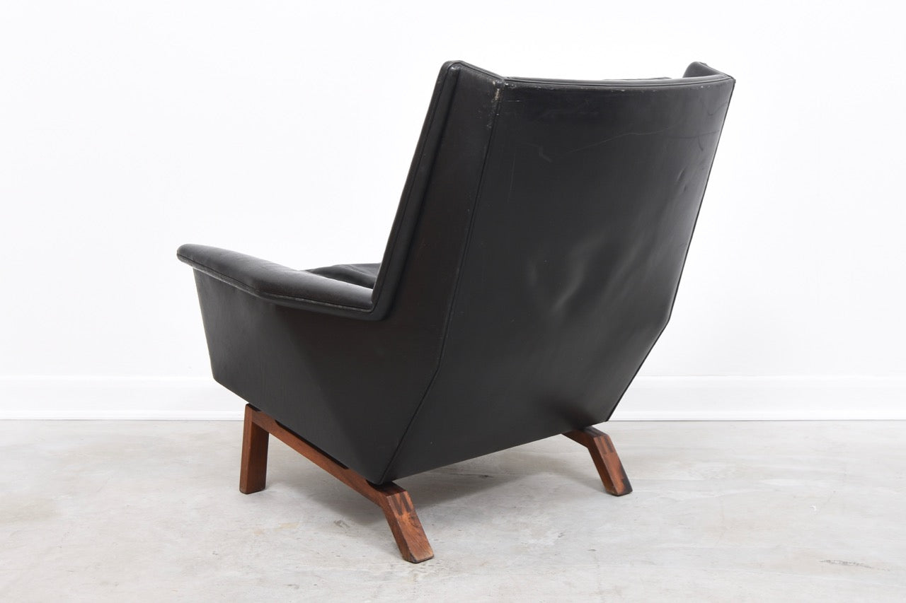 High back leather lounger on rosewood base