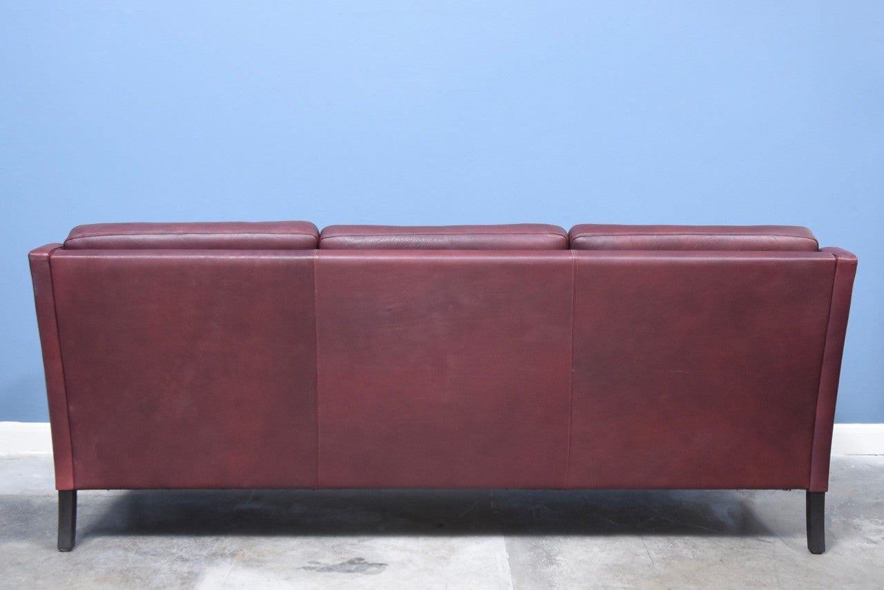 Three seat sofa in maroon leather