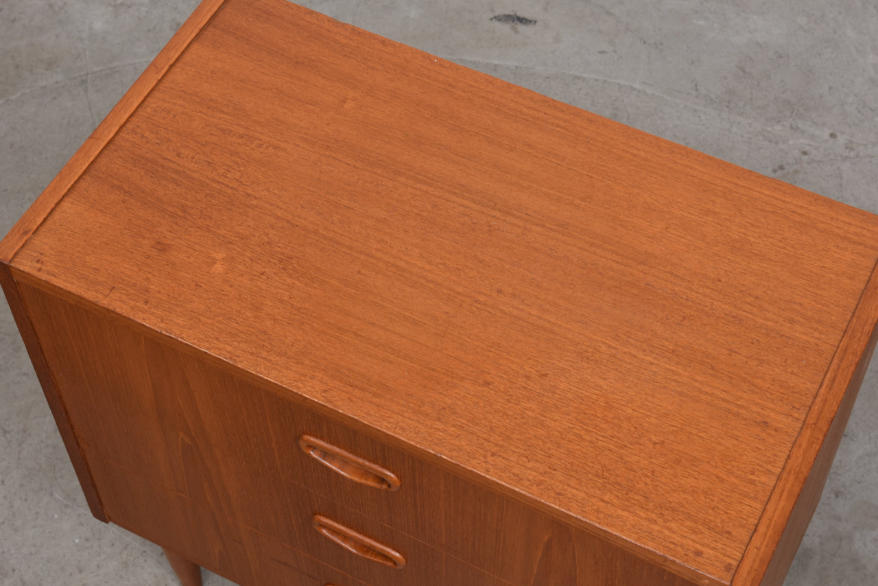 Low chest of three teak drawers