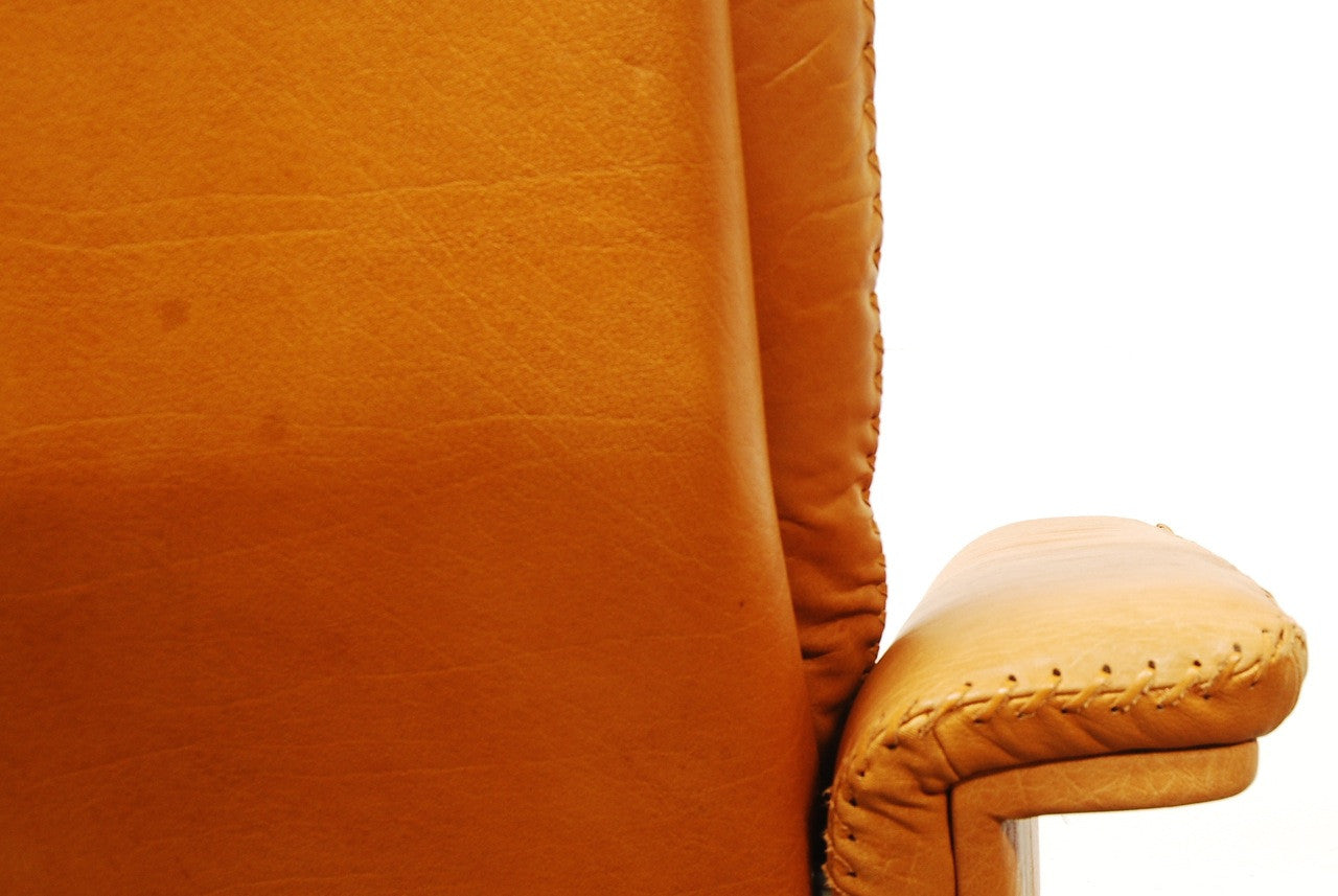 Tan leather lounger on swivel base