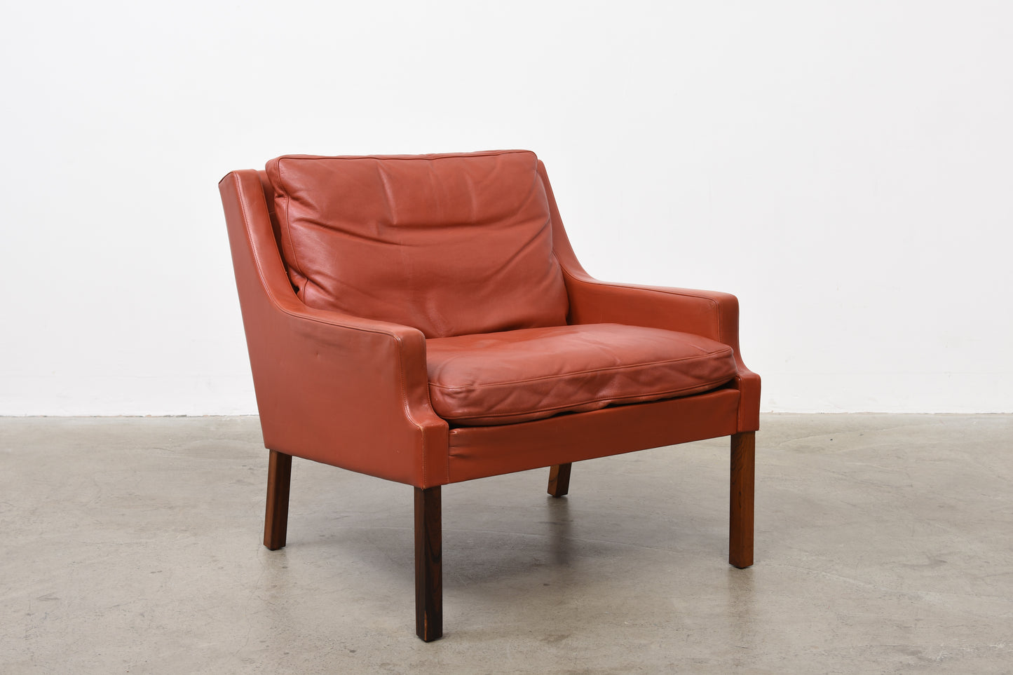Two available: Leather + rosewood loungers by Rud Thygesen