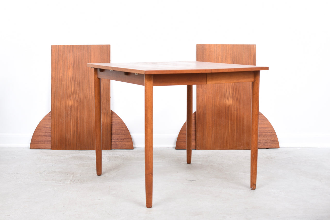 Extending square dining table in teak