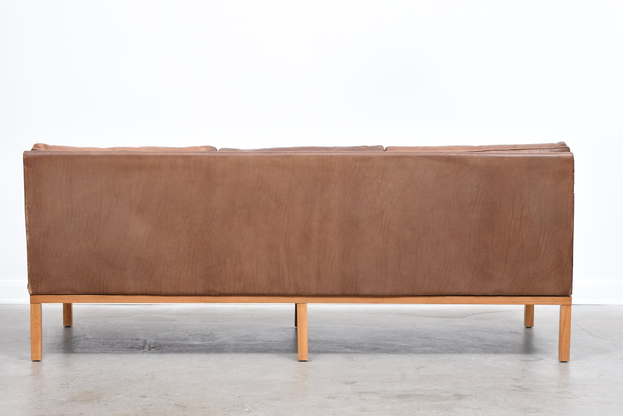 Vintage three seat leather sofa on oak base