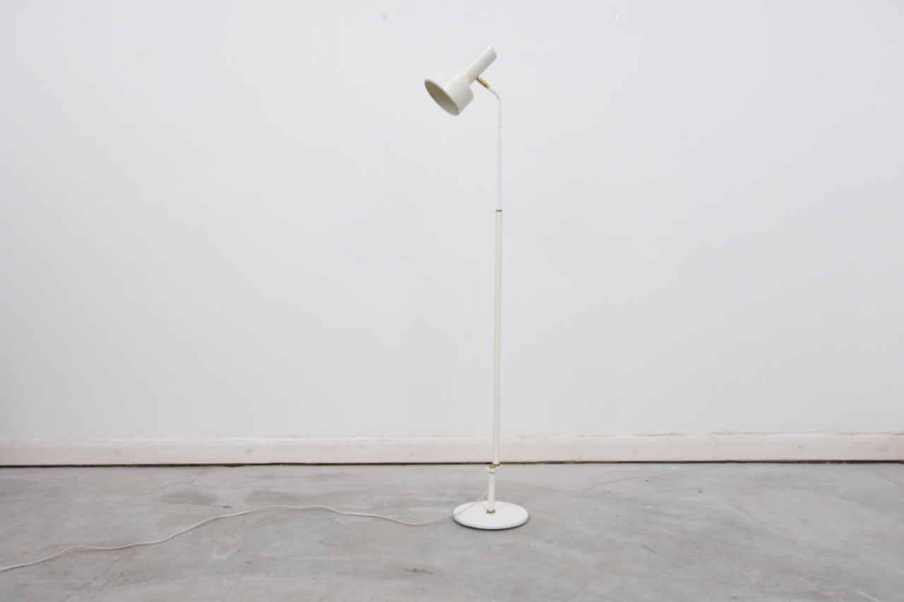 White floor lamp with brass detail