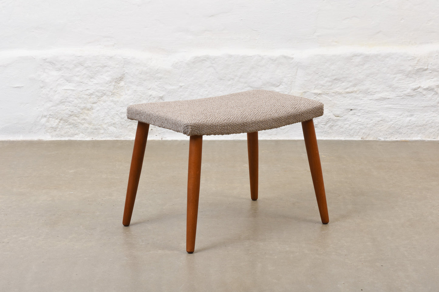 Newly reupholstered: 1960s footstool on beech legs