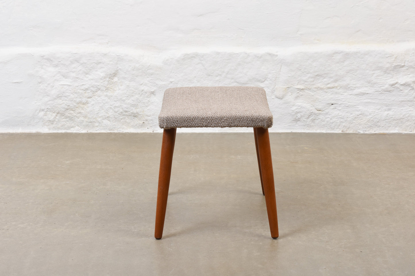 Newly reupholstered: 1960s footstool on beech legs