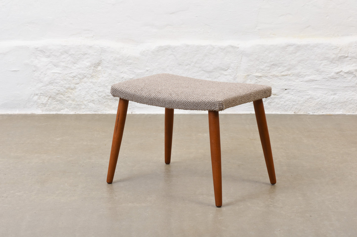 Newly reupholstered: 1960s footstool on beech legs