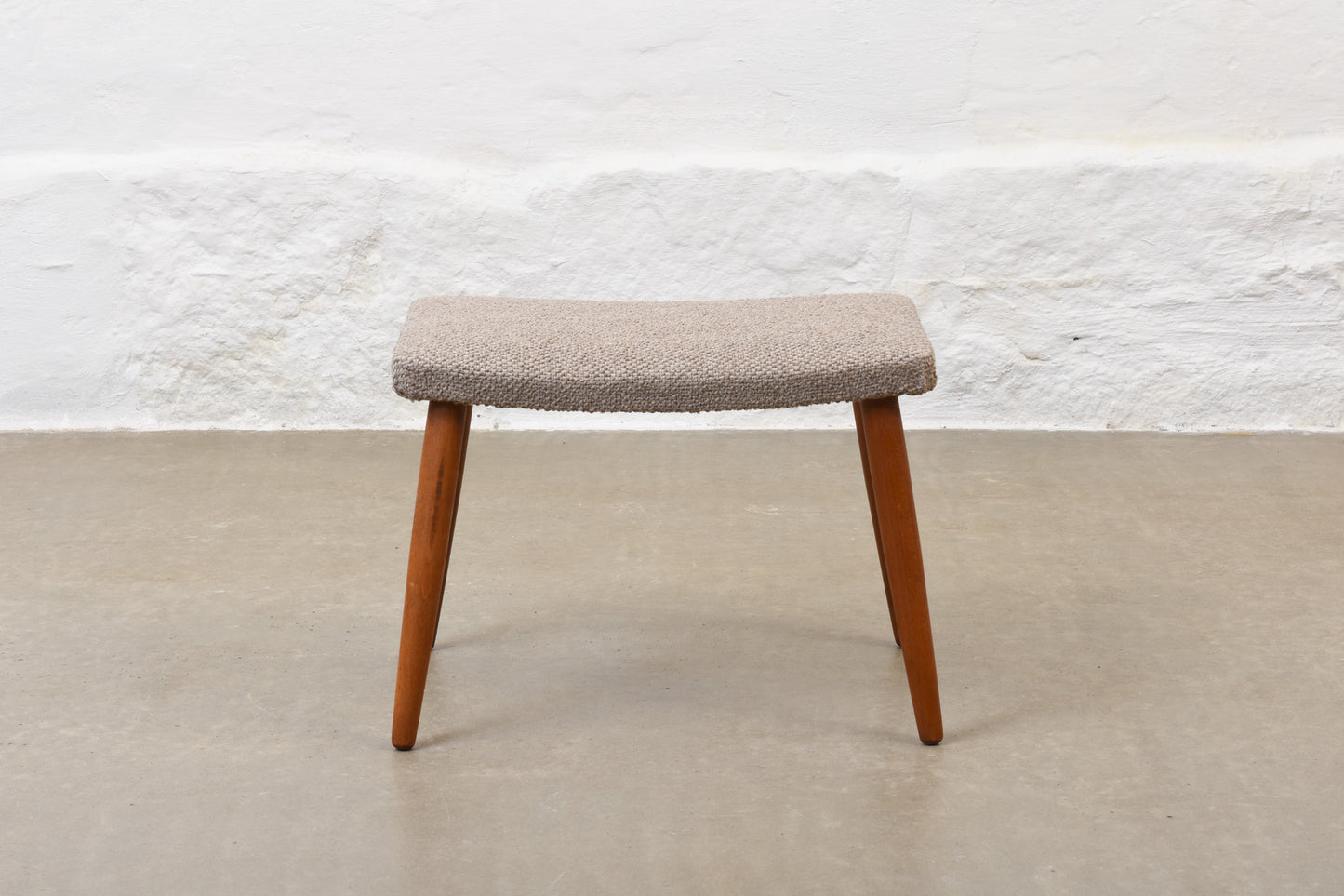 Newly reupholstered: 1960s footstool on beech legs