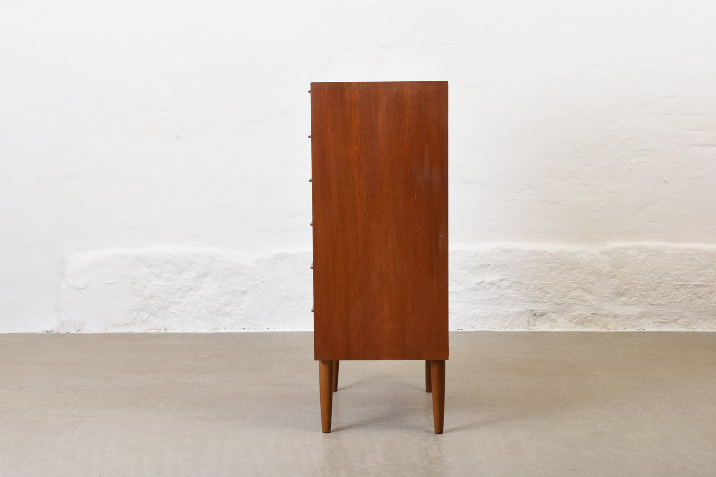 Narrow teak chest of drawers with lipped handles - 104H cm