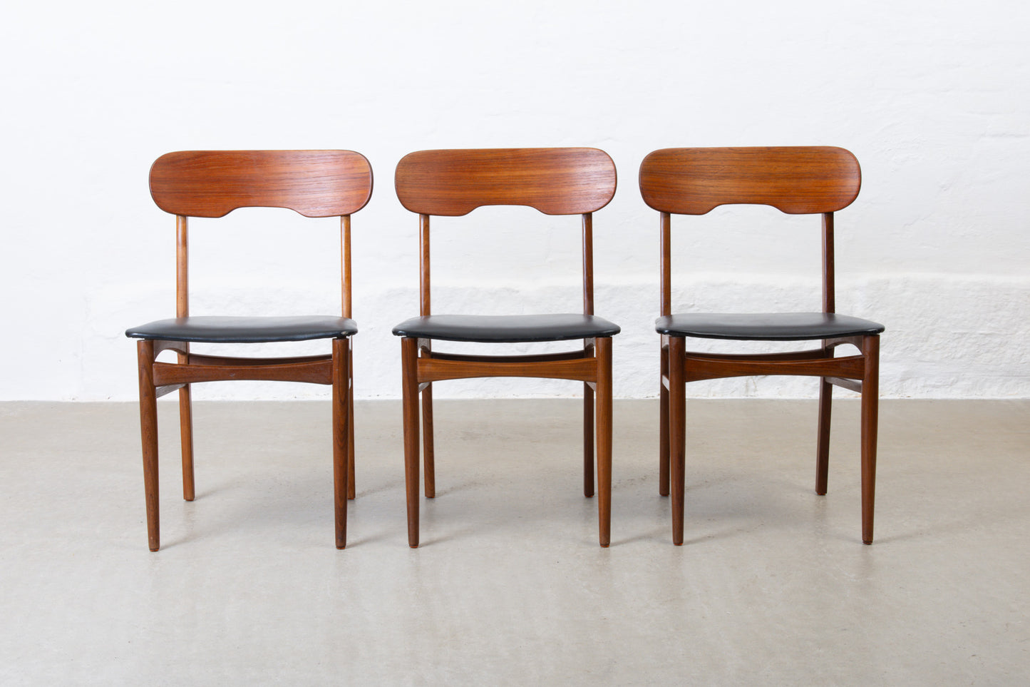 Three available: 1960s teak + vinyl chairs