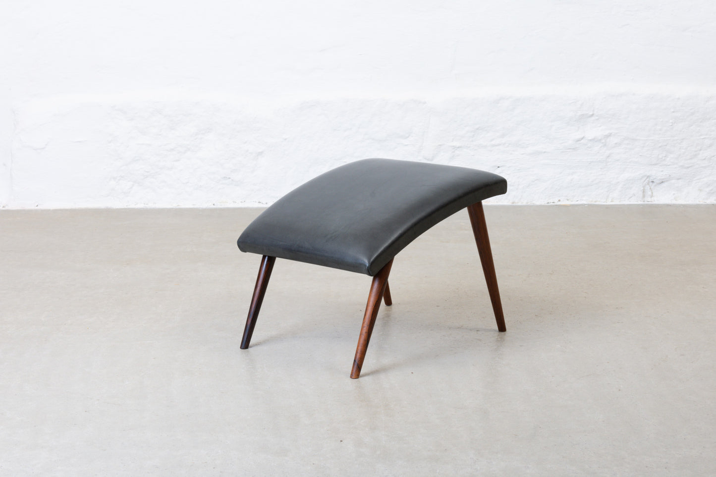 1960s leather foot stool on rosewood legs