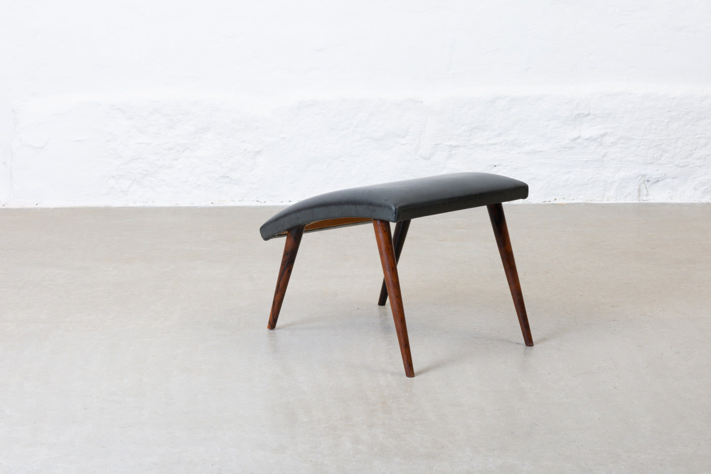 1960s leather foot stool on rosewood legs