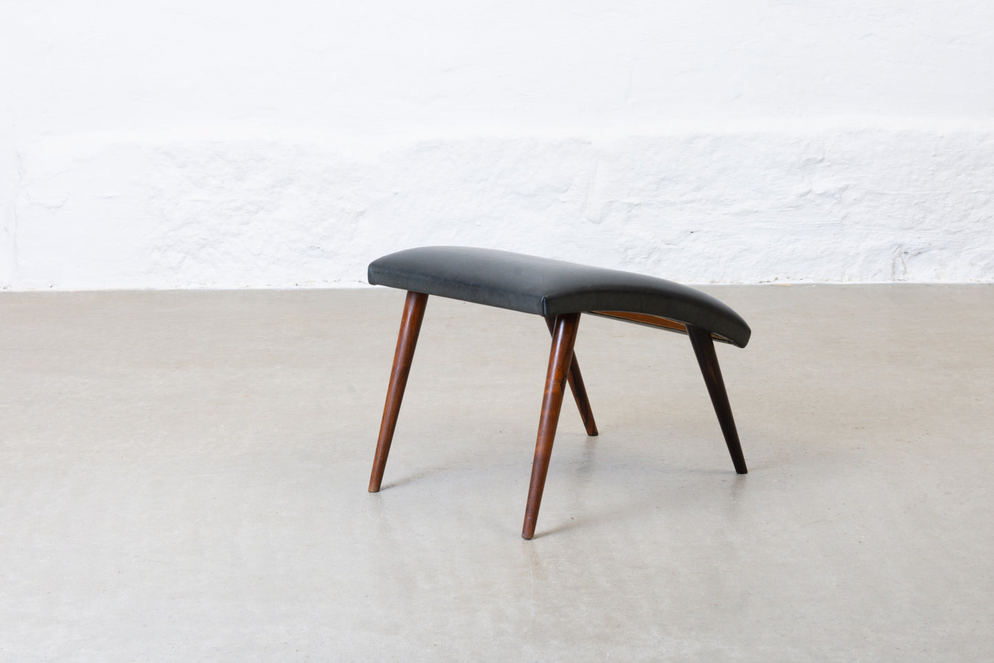 1960s leather foot stool on rosewood legs