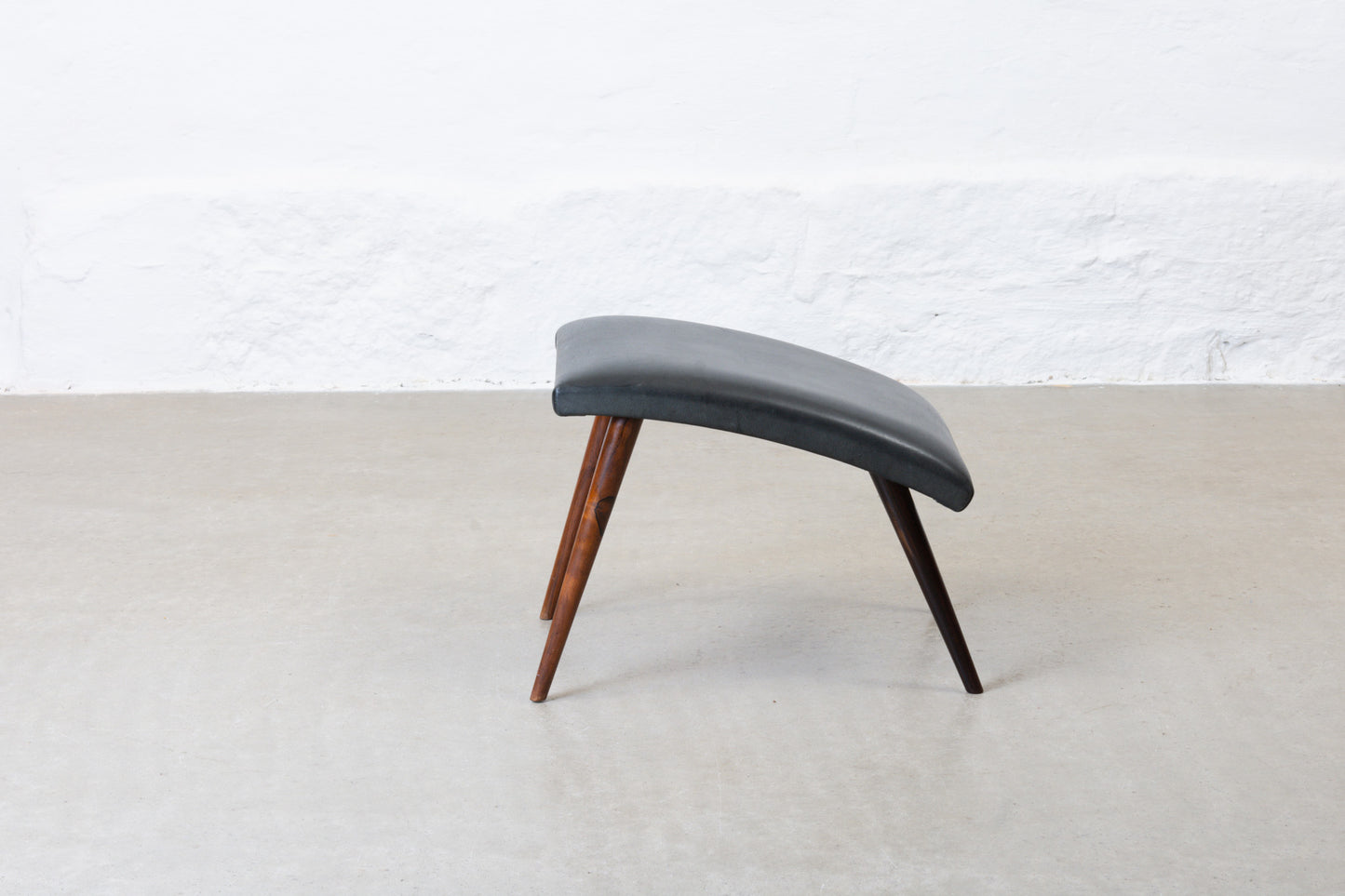 1960s leather foot stool on rosewood legs