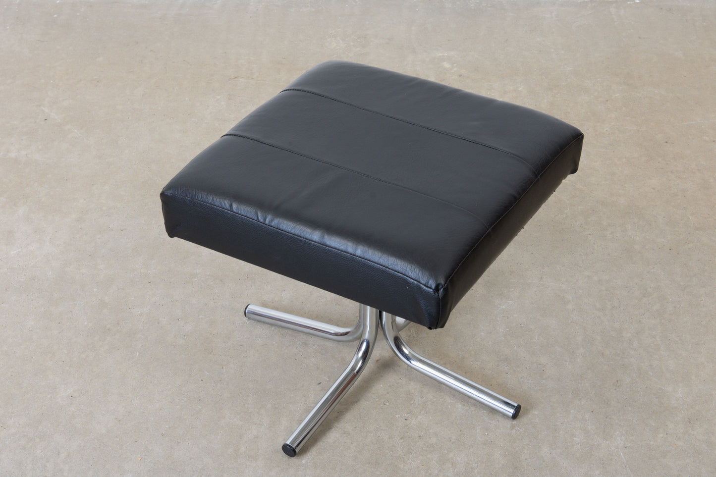 Vintage leather foot stool on metal base