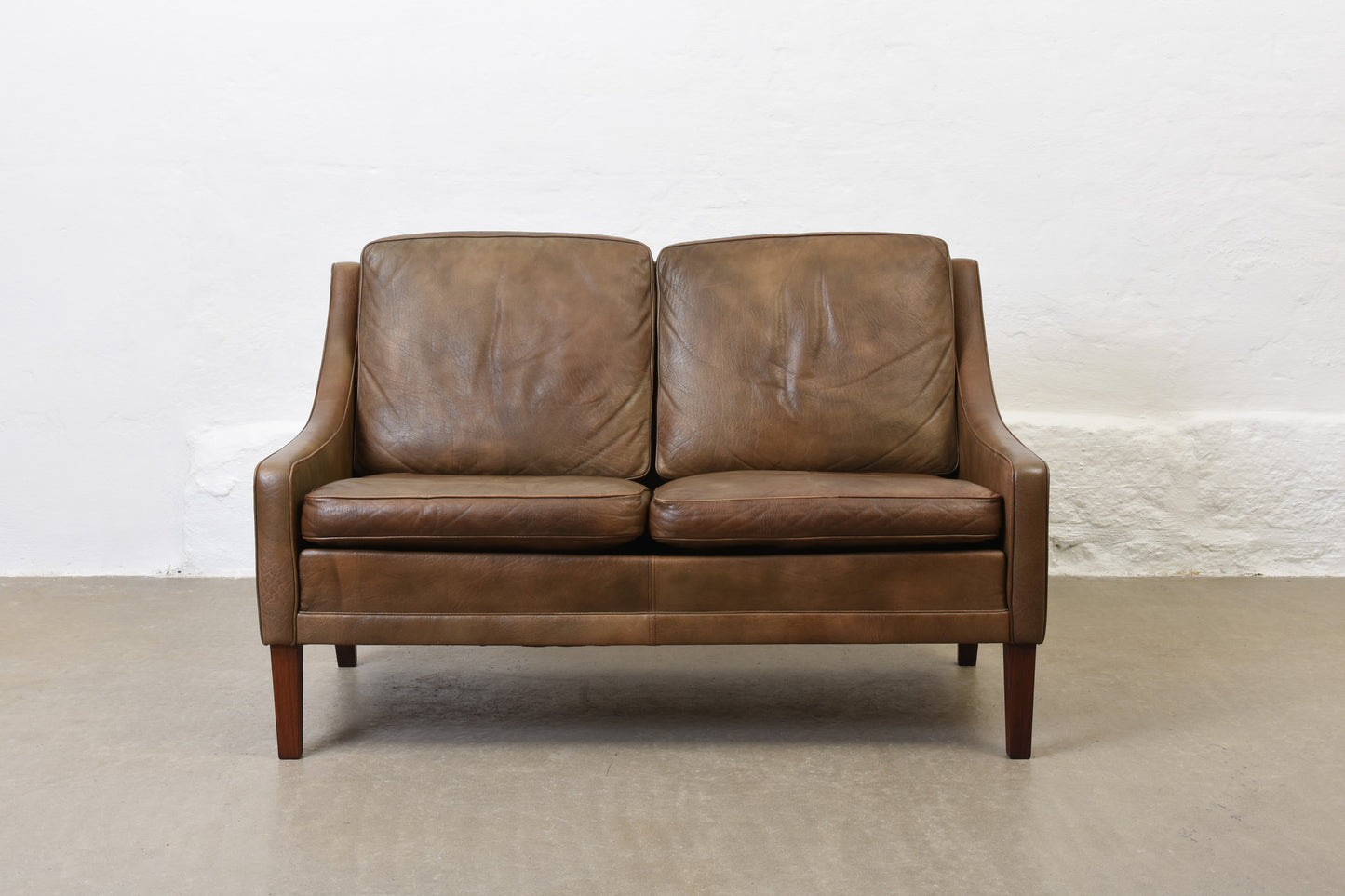 1960s two seat leather sofa on rosewood legs