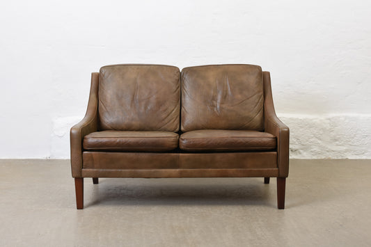 1960s two seat leather sofa on rosewood legs