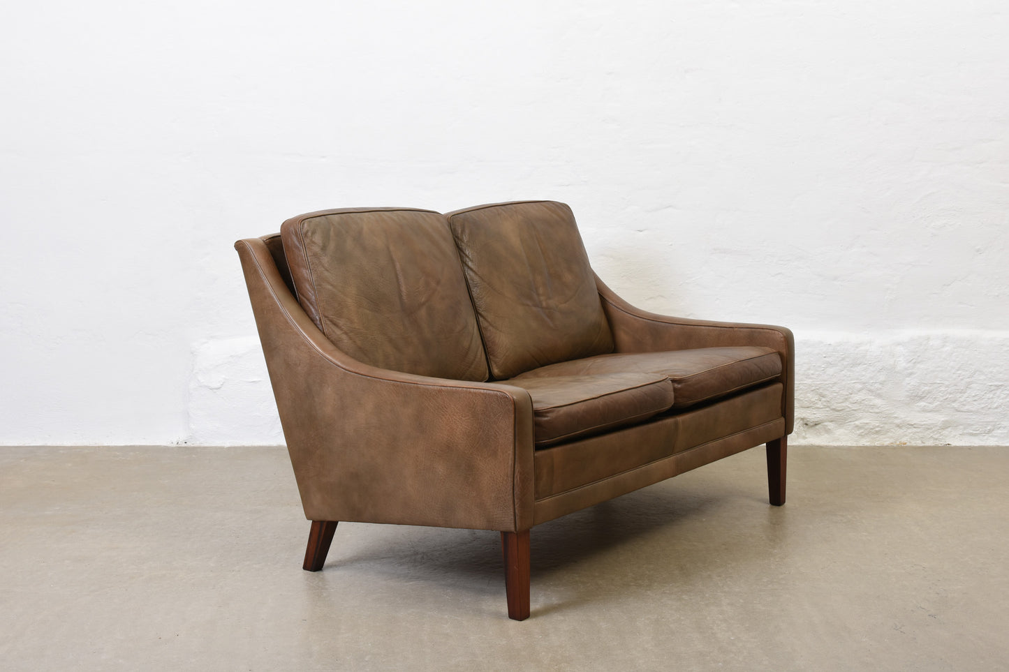 1960s two seat leather sofa on rosewood legs